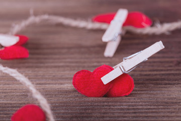 Two red textile hearts connected by clothespin. Love concept.