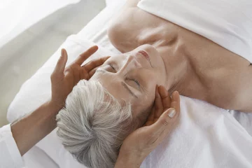 Rolgordijnen Closeup of a senior woman receiving massage at spa © moodboard