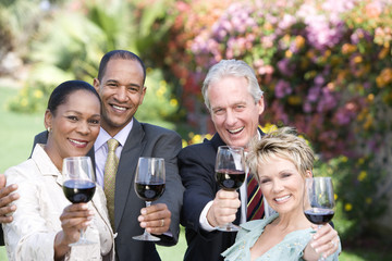 Portrait of happy multiracial friends toasting wine