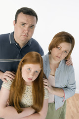 Obraz na płótnie Canvas Portrait of unhappy family standing together
