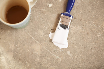 High angle view of coffee mug and paintbrush on floor