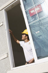 Male architect working near window at construction site