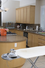 Interior of kitchen with ironing board
