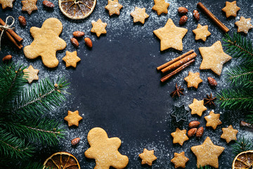 Christmas or New Year background with gingerbread cookies, gingerbread man cookies, stars, spices,...