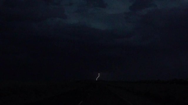 SLOW MOTION: Thunderstorm lightning bolt striking over the night sky