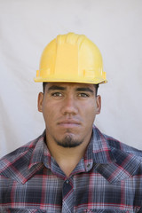 Portrait of a man wearing hardhat isolated on white background
