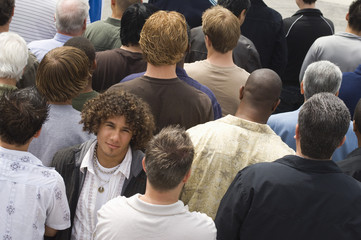 Fototapeta premium Portrait of young man surrounded by multiethnic men