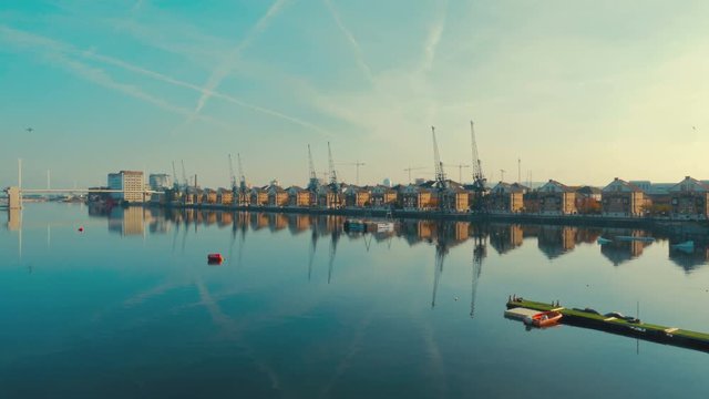An aerial view of East London docklands and the Thames on a day of a clear blue sky
