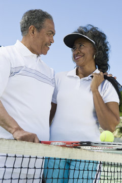 Loving senior African American couple at tennis court