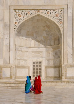 Women in brightly coloured saris at the Taj Mahal, Agra, Uttar Pradesh