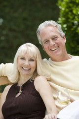 Portrait of a middle aged couple with wineglass in the garden