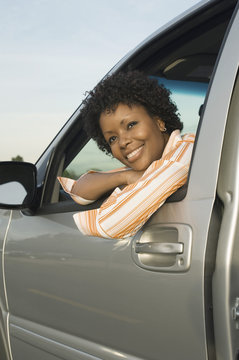 African American woman looking outside the window of a car