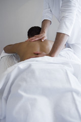 Obraz na płótnie Canvas An African American woman receiving back massage at resort spa
