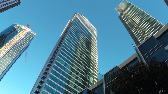 Driving through San Francisco downtown with high glassy skyscrapers