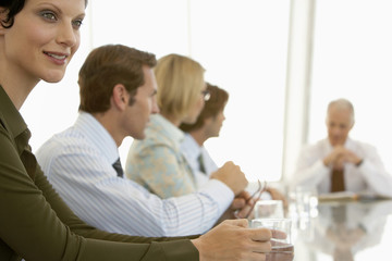 Fototapeta premium Young businesswoman with colleagues having a discussion in conference room
