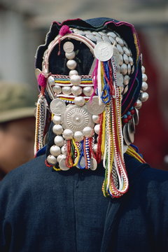 Close-up of silver and beads on an Aini Hani hat at Menghai, Yunnan Province, China