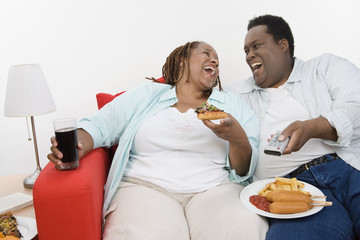 An African American couple looking at each other and laughing