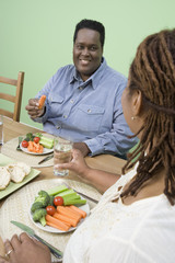 Obraz na płótnie Canvas Happy obese African American couple having healthy food together
