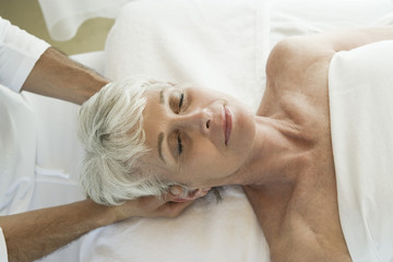 Senior woman having head massage