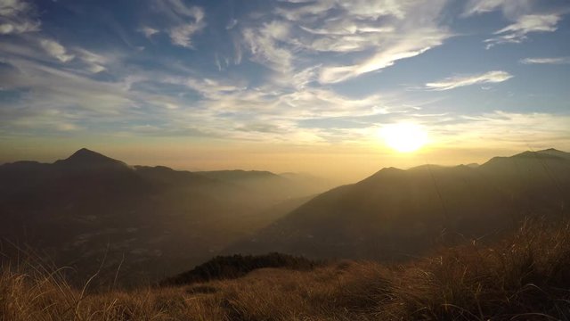 Time Lapse of a fiery sunset from mountain pick with thin glazes in the sky evening. Fall season. Orobie alps. Rena pick. Bergmo Italy.