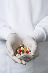 Closeup of pharmacist holding handful of pills