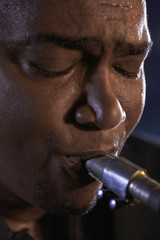 Closeup of an African American man playing saxophone