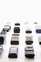 Row of old cell phones over white background