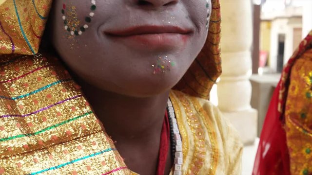 Young Girls on cell phone mobile dressed as Hindu goddess with make-up and traditional clothing at the Pushkar Mela festival in Rajasthan, India 