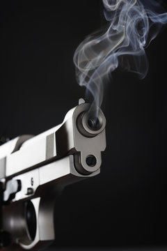 Smoking Handgun against black background
