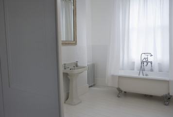 Interior of old styled bathroom with bathtub and sink