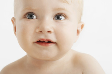 Closeup of cute baby with blue eyes isolated on white background