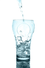  Ice cubes in glass with splash water on reflection surface