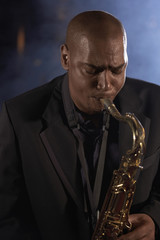 Fototapeta na wymiar Musician playing saxophone in the jazz club
