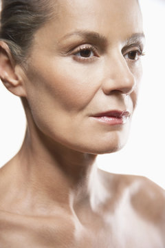 Closeup Of Thoughtful Middle Aged Woman Looking Away On White Background