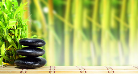 Obraz na płótnie Canvas Spa concept zen basalt stones with bamboo