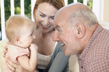 Closeup of a happy grandparent with daughter and granddaughter