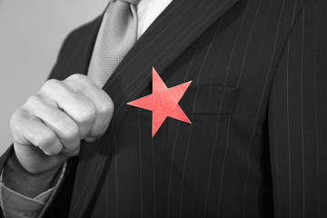 Extreme closeup of a businessman with red star on suit