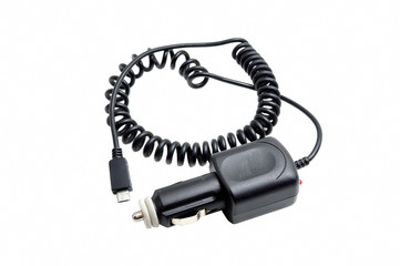 Car battery charger for mobile phones, laptops, etc. Charges your cell phone via the mini-USB connector. Fits into your car cigarette lighter socket. Isolated on white background