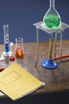 Bunsen burner tripod flask and test tubes in science laboratory