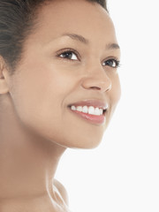 Headshot of an attractive young woman smiling against white background