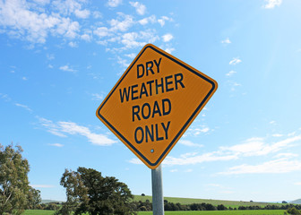 black and yellow dry weather only sign