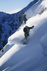 Full length of snowboarder in motion on mountain slope
