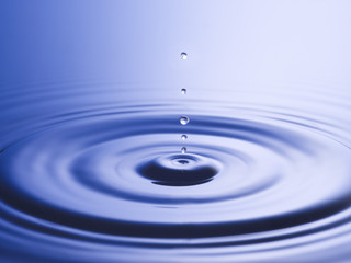 Drops hitting surface of water close-up