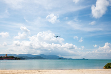 Plane over the blue sea