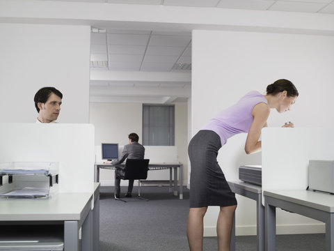 Pervert businessman watching female colleague in office