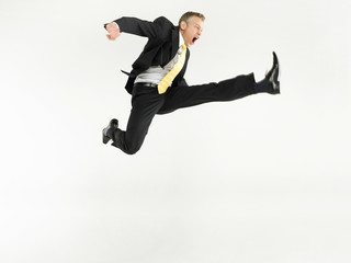 Full length portrait of a businessman jumping against white background