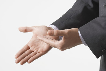 Closeup of business hands gesturing against white background