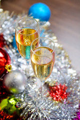 Cristmas glasses with champagne on cristmas decoration background