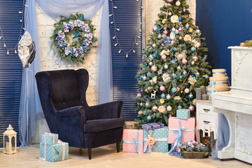 Beautiful Christmas decor, New year toys, glow in the dark garland. Christmas tree decorated with toys and balloons. Festive mood before Christmas eve. The house is decorated before the holiday