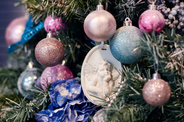 Beautiful Christmas decor, New year toys, glow in the dark garland. Christmas tree decorated with toys and balloons. Festive mood before Christmas eve. The house is decorated before the holiday